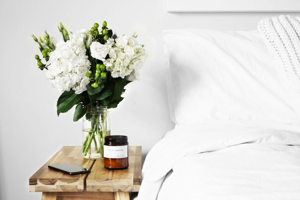 Bouquet of flowers sitting on bedside table to represent sex therapy