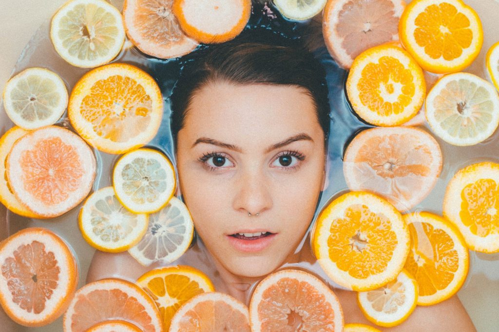oranges around the woman