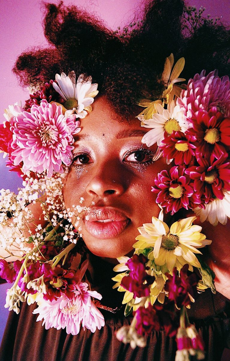 Woman's face surrounded by flowers to represent support groups for women
