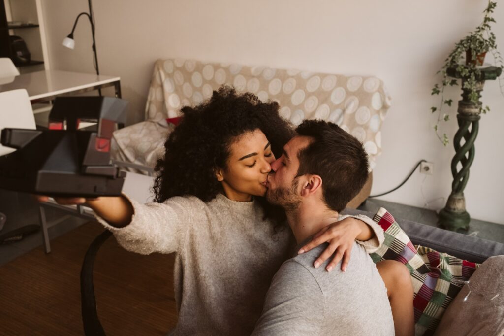 Couple taking selfie on couch