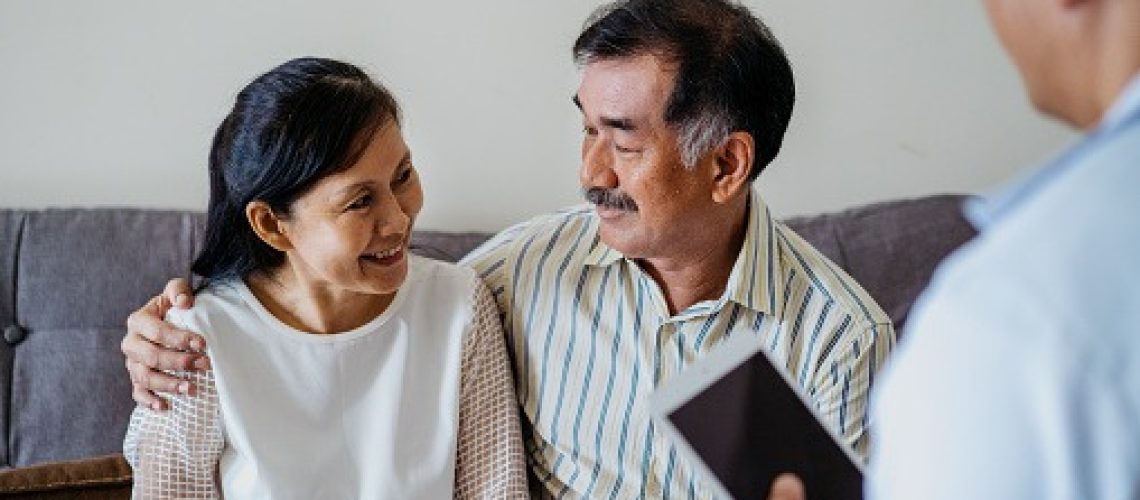 mature couple smiling in front of the therapist
